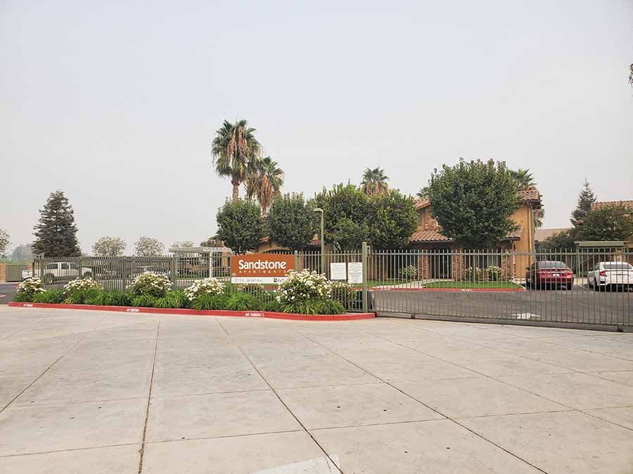 Entry sign to community l Sandstone Apartments in Fresno CA